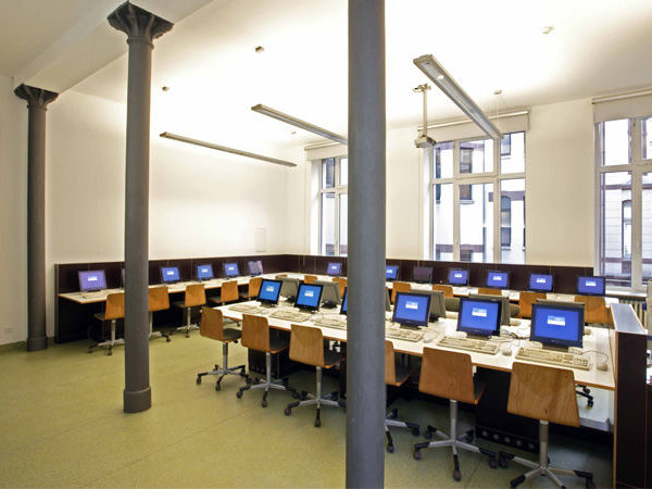 Blick in einen Raum mit ungefähr zwanzig Computer-Arbeitsplätzen im Schulhaus der Dr. Buhmann Schule & Akademie in Hannover